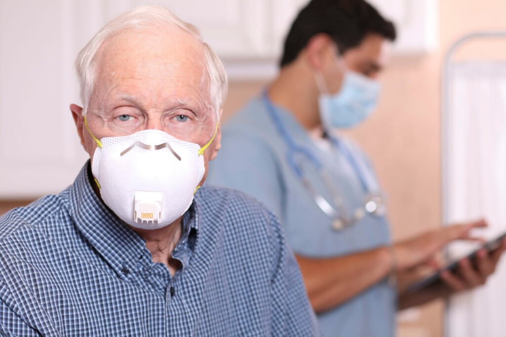 older man wearing n95 mask G 1257850122